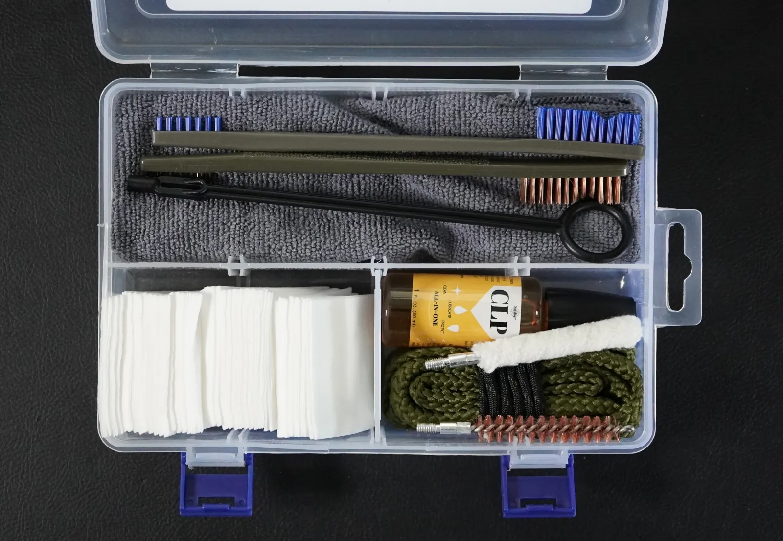 RoundKeep 9mm Handgun Cleaning Kit contents laid out: bore snake, one-piece rod, brushes, CLP, patches, and microfiber cloth in a compartment case