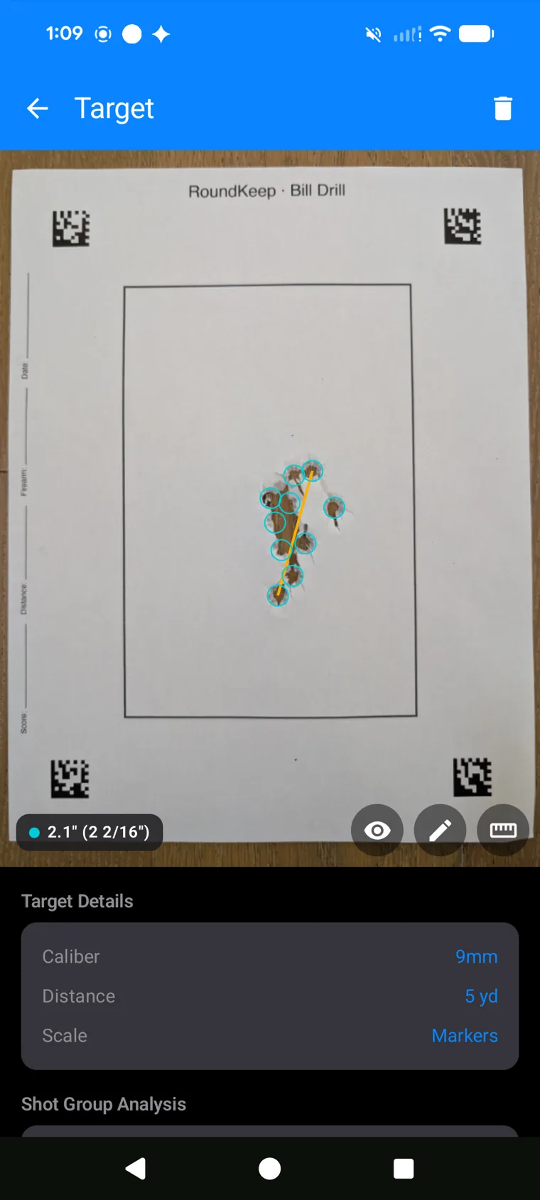 RoundKeep measuring a 2.1-inch group on a printed Bill Drill target