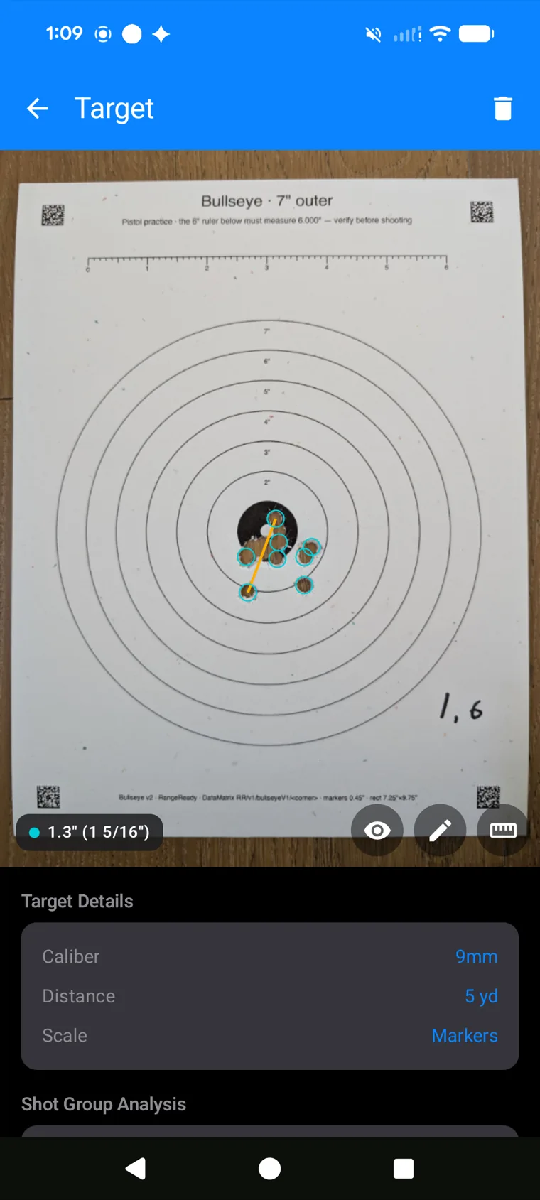 RoundKeep measuring a 1.3-inch group on a printed Bullseye target