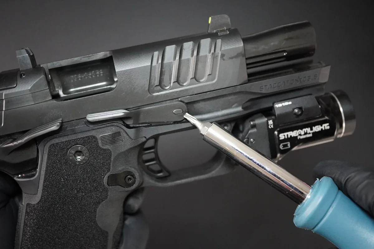 Using a small punch from the right side of a new Staccato HD 3.6 to push the slide stop out