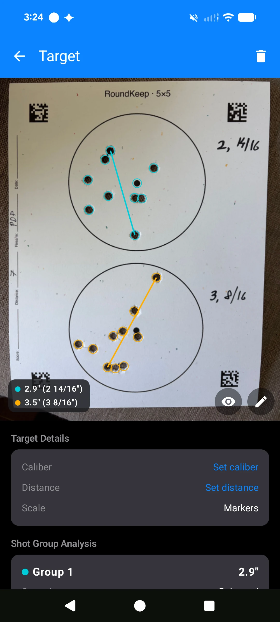 RoundKeep Zero measuring two shot groups on a 5×5 drill target — 2.9 inch and 3.5 inch extreme spread